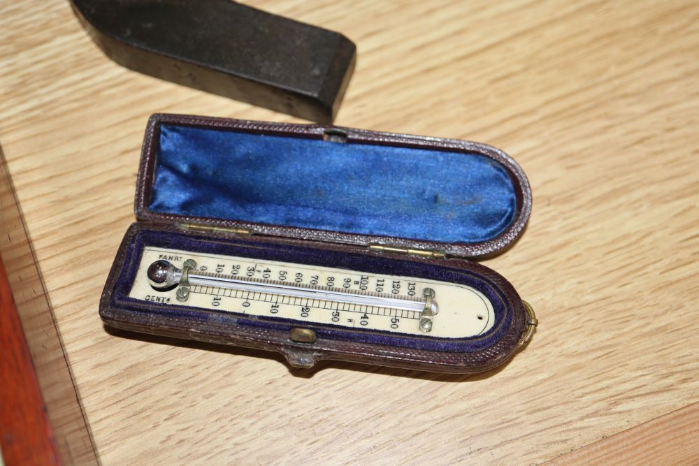 A cased microscope, a cased Sikes hydrometer and two thermometers